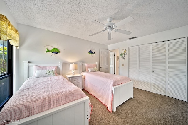 bedroom featuring ceiling fan, a textured ceiling, a closet, and dark carpet