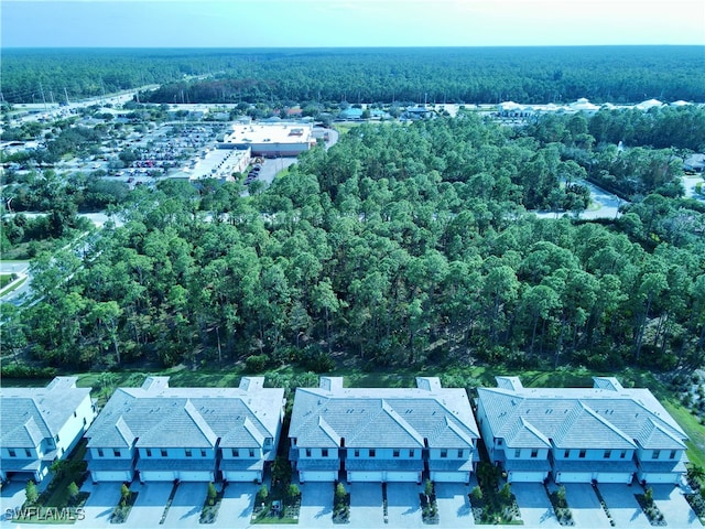 birds eye view of property featuring a residential view and a wooded view