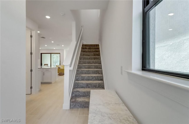 staircase featuring recessed lighting