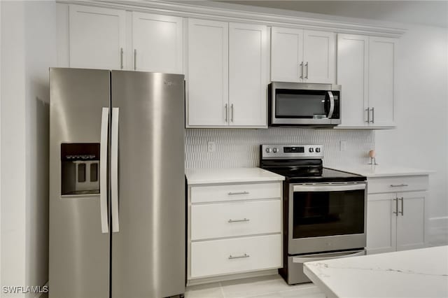 kitchen featuring white cabinetry, backsplash, and appliances with stainless steel finishes