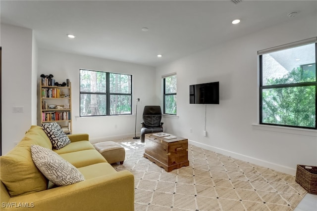 living room with plenty of natural light, recessed lighting, and baseboards