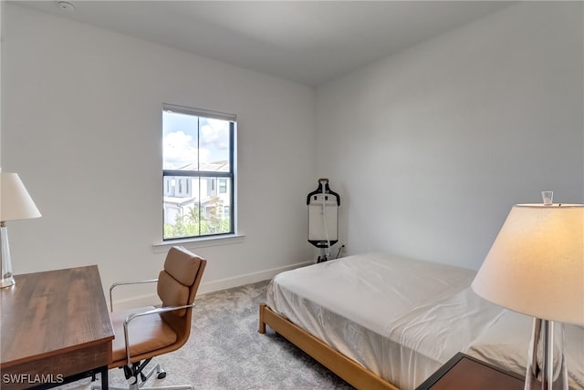 carpeted bedroom featuring baseboards