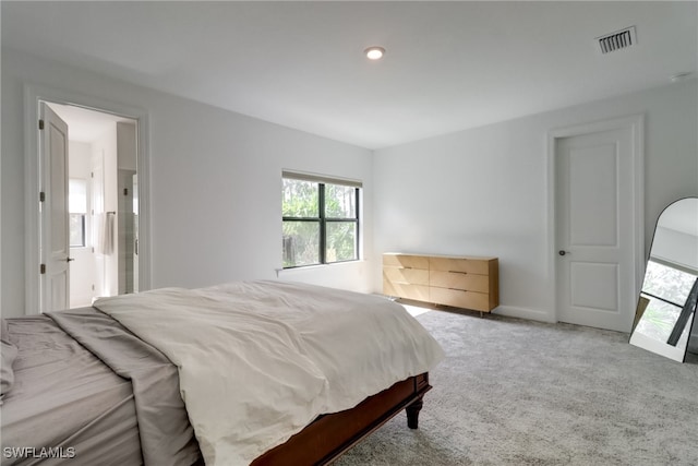 bedroom featuring visible vents, baseboards, and carpet