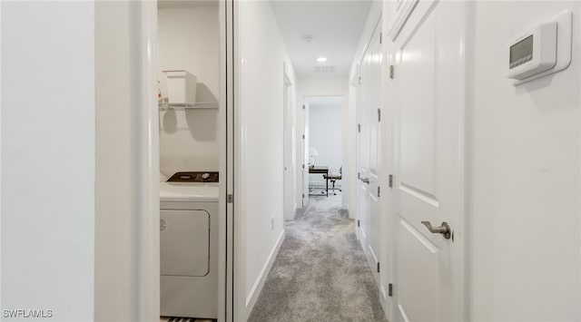 hall with visible vents, washer / clothes dryer, carpet, and baseboards