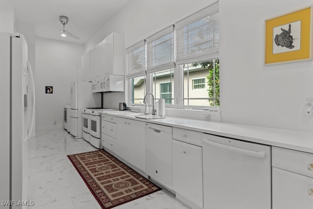 kitchen with sink, white cabinetry, white appliances, and ceiling fan