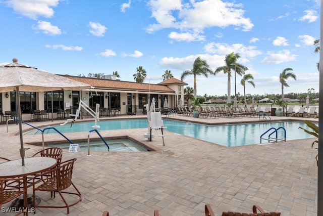 view of swimming pool featuring a patio area and a community hot tub