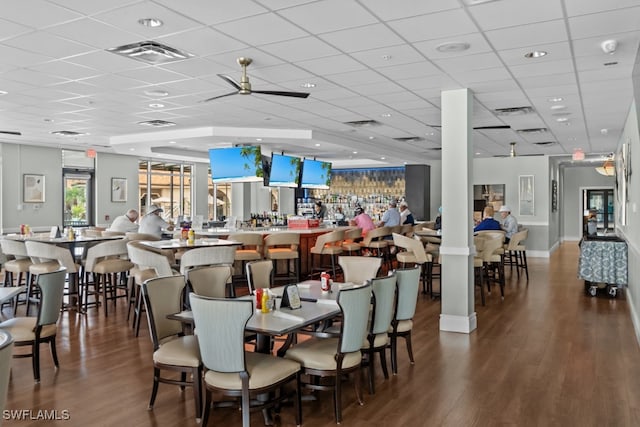 dining room featuring hardwood / wood-style floors, a paneled ceiling, and ceiling fan