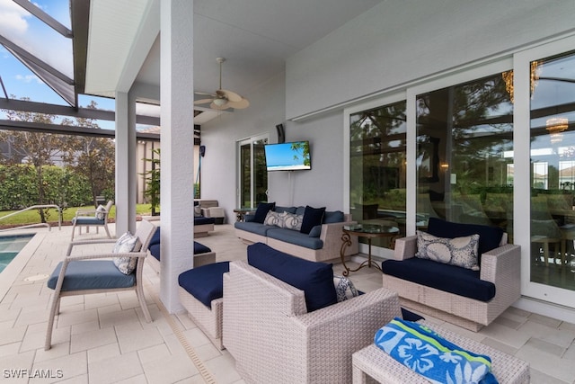 view of patio / terrace with a lanai, an outdoor living space, a swimming pool, and ceiling fan