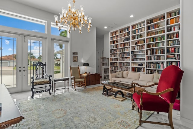 sitting room featuring a wealth of natural light, french doors, and a notable chandelier