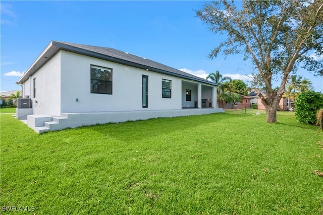 rear view of house featuring a yard