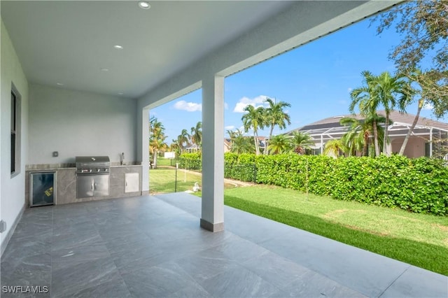 view of patio with an outdoor kitchen, a grill, a lanai, and sink