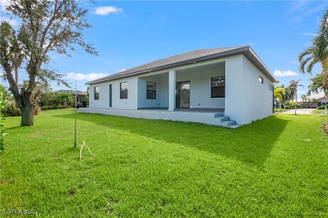 back of house featuring a lawn