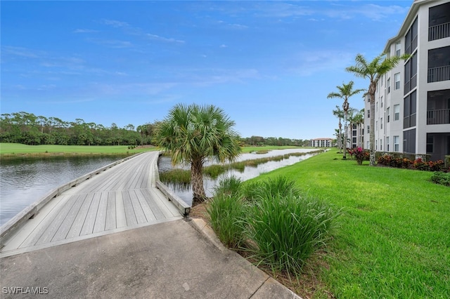 view of home's community featuring a yard and a water view