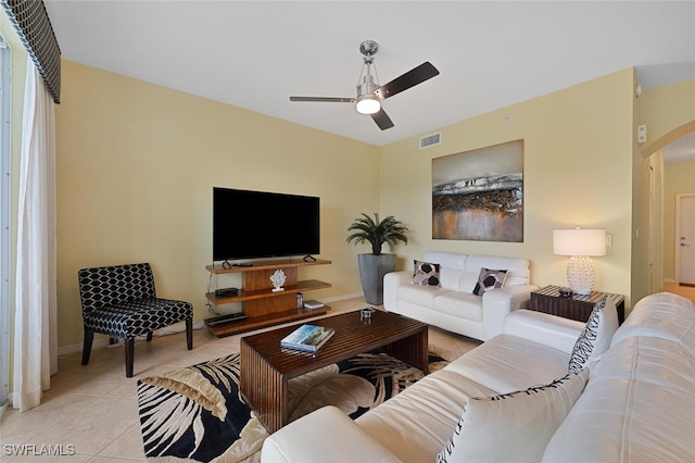 tiled living room featuring ceiling fan