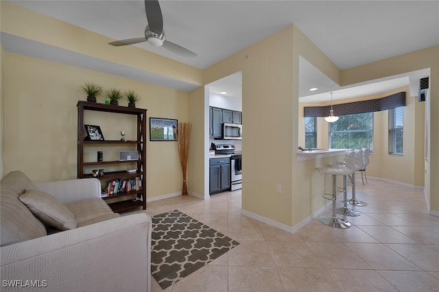 living room with ceiling fan and light tile patterned flooring