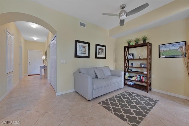 tiled living room featuring ceiling fan