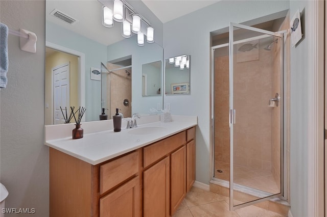 bathroom featuring vanity, an enclosed shower, and tile patterned flooring