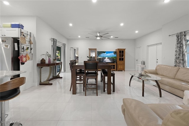 tiled dining area with ceiling fan