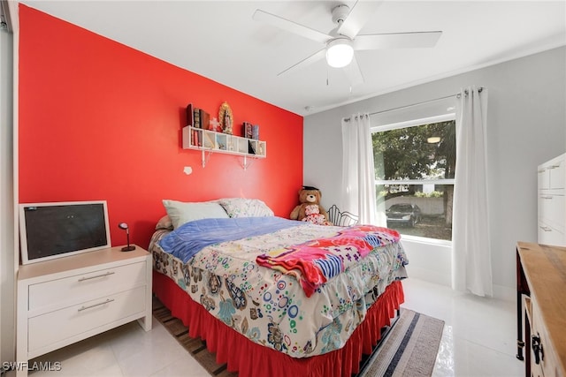 tiled bedroom featuring ceiling fan