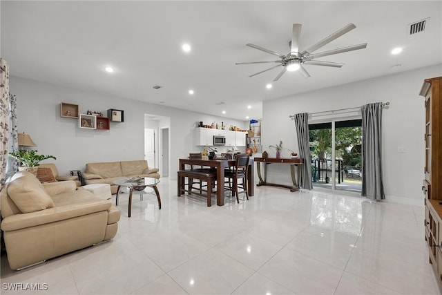 tiled living room featuring ceiling fan