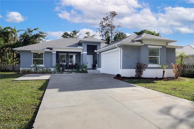 view of front of property featuring a garage and a front lawn