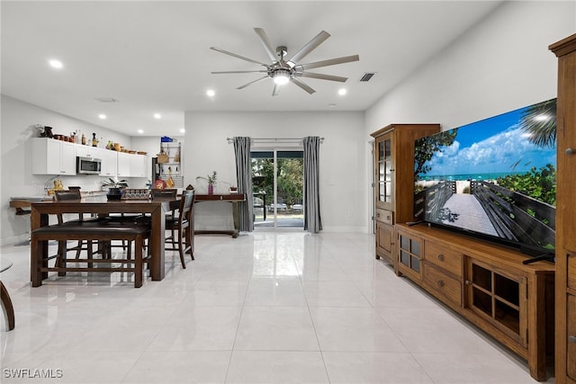 tiled dining area with ceiling fan