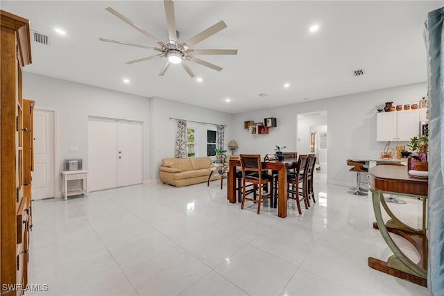 tiled dining space featuring ceiling fan