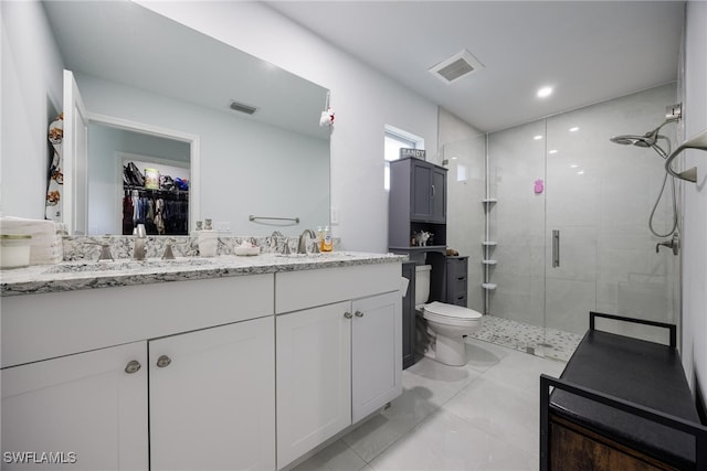 bathroom with vanity, toilet, and a shower with door