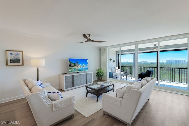 living room featuring ceiling fan, light hardwood / wood-style flooring, and floor to ceiling windows