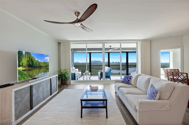 living room with ceiling fan, crown molding, hardwood / wood-style floors, and a water view