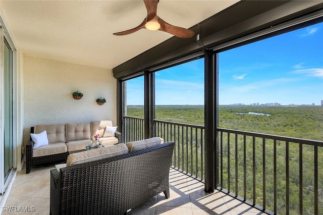 sunroom / solarium featuring ceiling fan