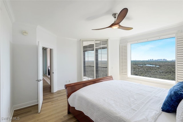 bedroom featuring ceiling fan, light hardwood / wood-style flooring, and crown molding