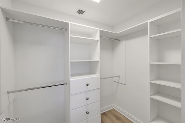 spacious closet featuring visible vents and light wood-style floors