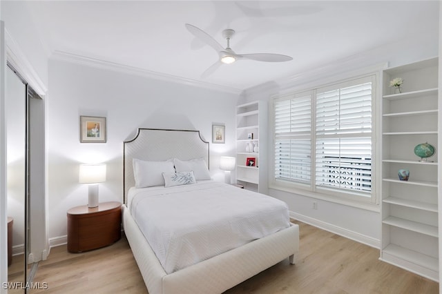 bedroom featuring a closet, crown molding, light wood-type flooring, and ceiling fan