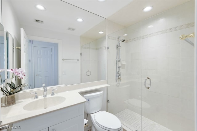 bathroom with an enclosed shower, vanity, and toilet