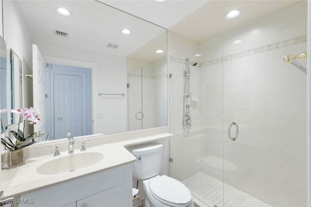 bathroom featuring a stall shower, visible vents, and toilet