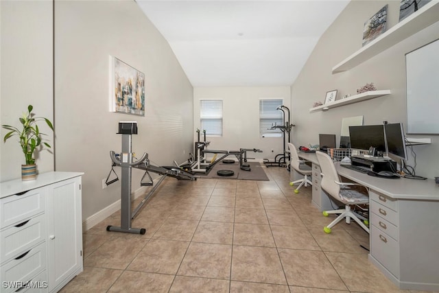 home office with lofted ceiling and light tile patterned floors