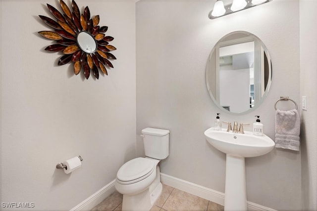 bathroom featuring tile patterned floors, toilet, and sink