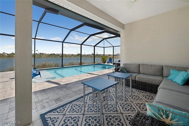 view of swimming pool with a water view, ceiling fan, a patio, outdoor lounge area, and glass enclosure