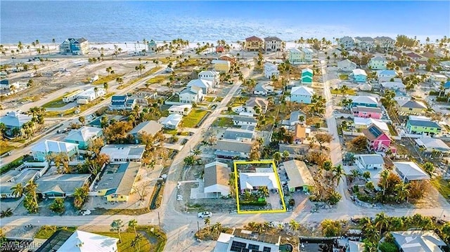 drone / aerial view featuring a residential view and a water view