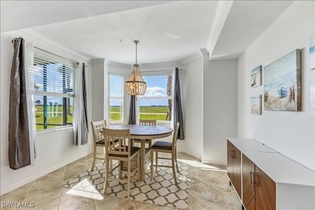 dining space featuring ornamental molding, plenty of natural light, and a chandelier