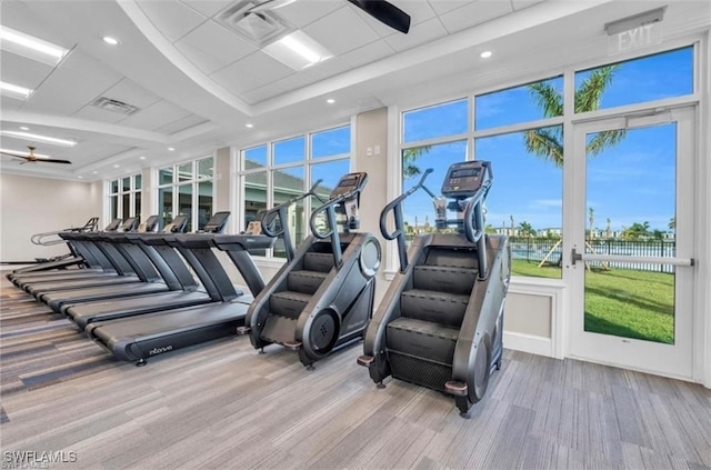 workout area featuring ceiling fan and light hardwood / wood-style floors