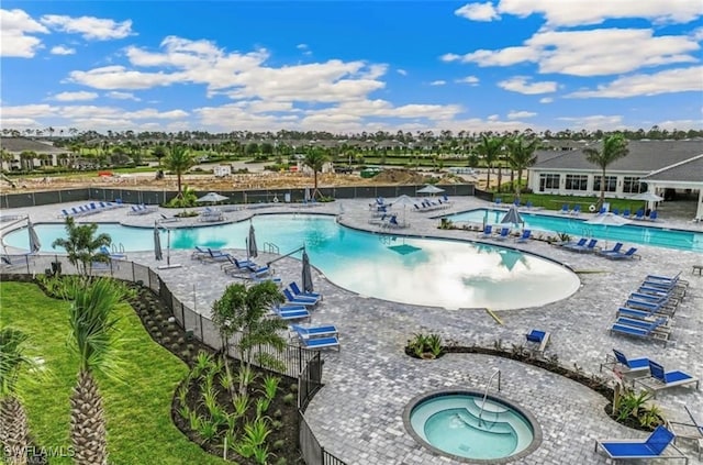 view of swimming pool with a patio and a hot tub