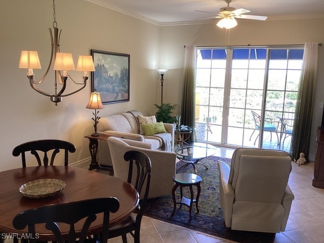 dining space featuring light tile patterned flooring, ceiling fan with notable chandelier, and crown molding