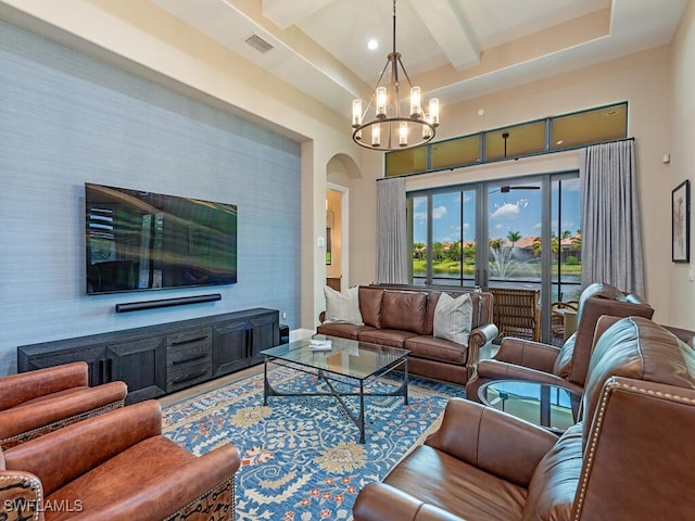 living room with french doors, beamed ceiling, and a notable chandelier