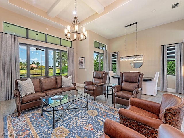 living room featuring a notable chandelier, beam ceiling, and hardwood / wood-style floors