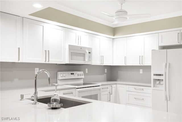 kitchen with white appliances, white cabinets, and ceiling fan