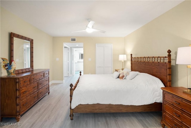 bedroom featuring a ceiling fan, visible vents, baseboards, a closet, and light wood finished floors