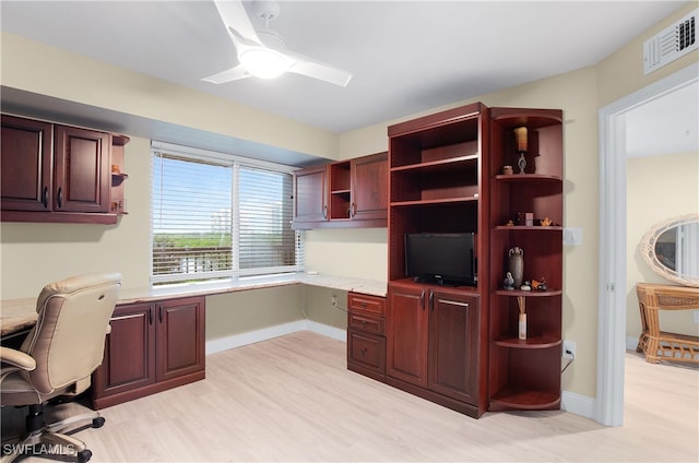 office with ceiling fan, built in desk, and light hardwood / wood-style flooring