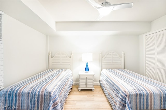 bedroom featuring ceiling fan, a closet, and light hardwood / wood-style floors